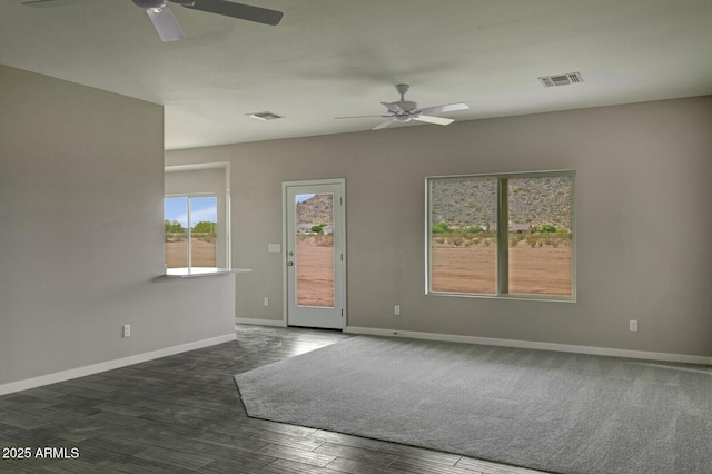 unfurnished room with dark wood-type flooring and ceiling fan