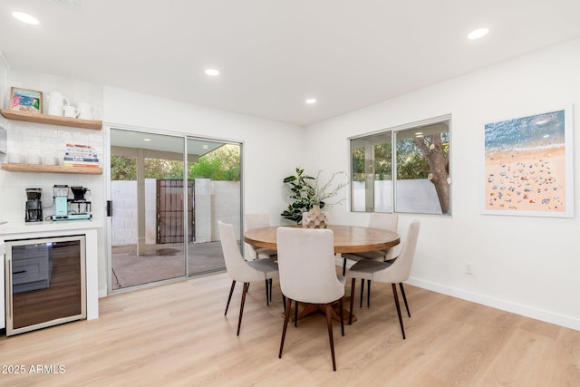 7223 N 14th St, Phoenix, AZ 85020 - dining space featuring light wood-style flooring, a bar, plenty of natural light, wine cooler, and recessed lighting