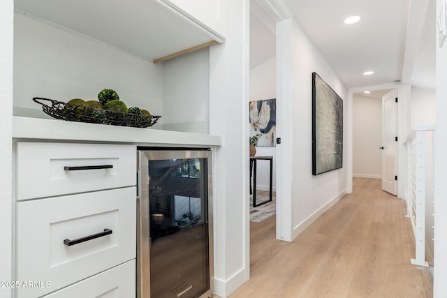 7223 N 14th St, Phoenix, AZ 85020 - hallway with wine cooler, light wood finished floors, recessed lighting, and baseboards
