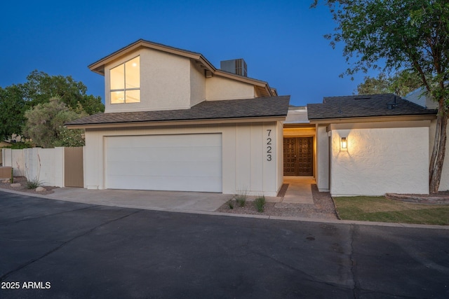7223 N 14th St, Phoenix, AZ 85020 - view of front of property with cooling unit, driveway, stucco siding, and an attached garage