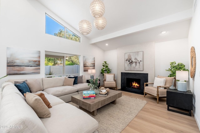 7223 N 14th St, Phoenix, AZ 85020 - living room with light wood-type flooring, a fireplace with flush hearth, a chandelier, high vaulted ceiling, and recessed lighting