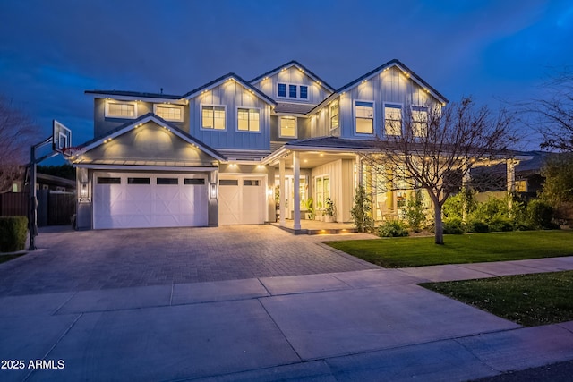 view of front of property with a garage and a front lawn