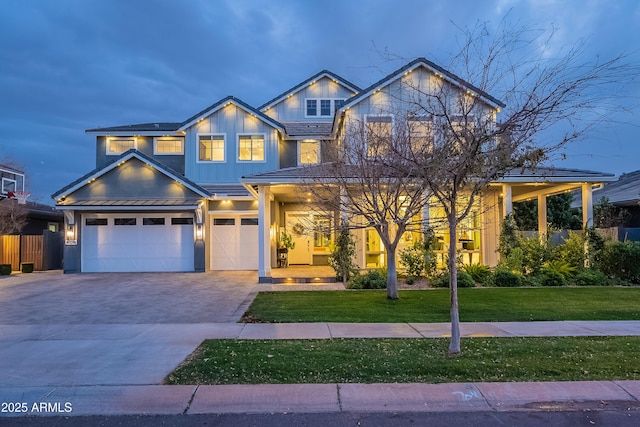 craftsman-style home with a garage and a front yard