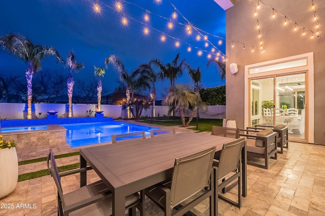 pool at twilight featuring a patio