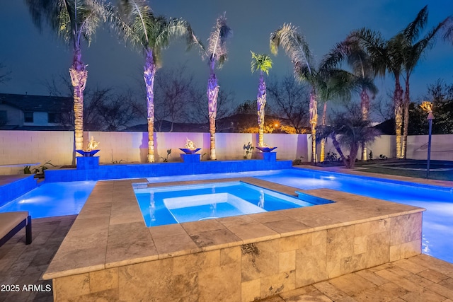 view of swimming pool featuring an in ground hot tub and pool water feature