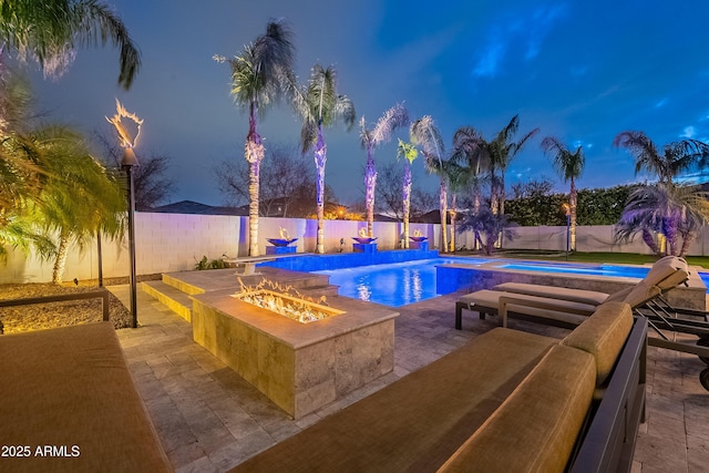 view of swimming pool with a fire pit and a patio