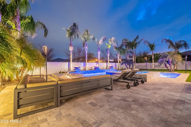 patio terrace at dusk featuring outdoor lounge area and a pool with hot tub