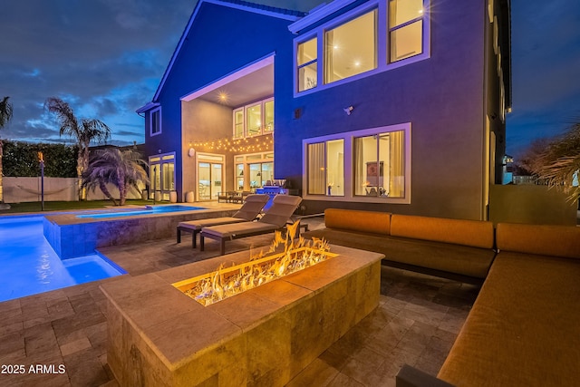 view of swimming pool featuring an in ground hot tub, a patio area, and a fire pit