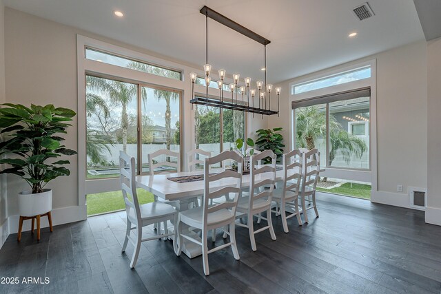 dining space with an inviting chandelier and dark wood-type flooring