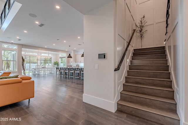 stairs featuring hardwood / wood-style floors