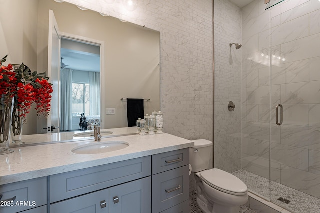 bathroom with walk in shower, vanity, and toilet