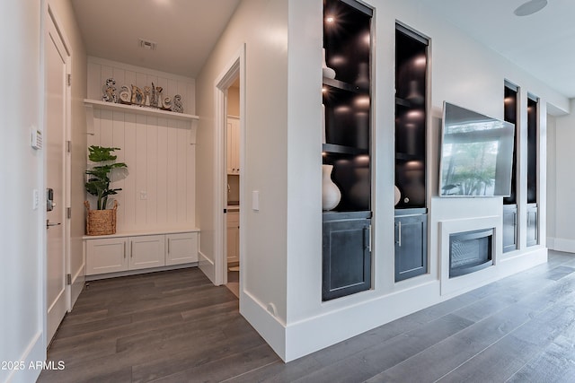 corridor with dark hardwood / wood-style flooring