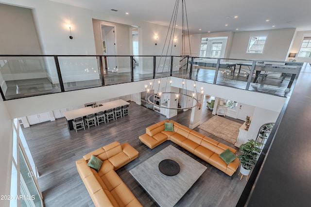 living room featuring dark hardwood / wood-style flooring and a notable chandelier