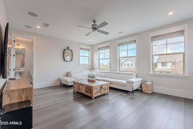 living room featuring hardwood / wood-style floors and ceiling fan