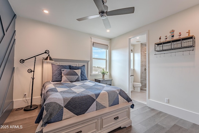 bedroom with ceiling fan, connected bathroom, and light hardwood / wood-style flooring