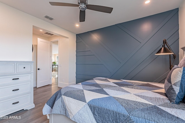 bedroom featuring hardwood / wood-style flooring and ceiling fan