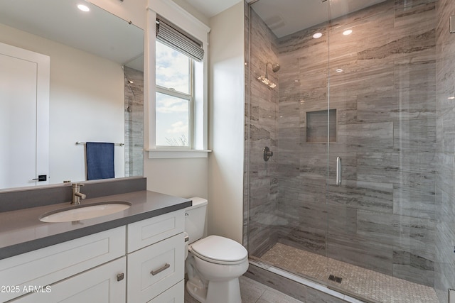 bathroom featuring vanity, toilet, and walk in shower