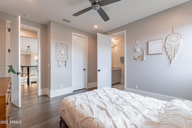 bedroom with ensuite bathroom and hardwood / wood-style floors