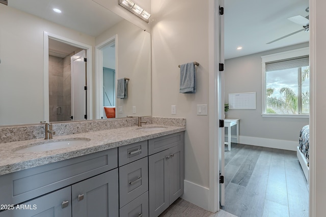 bathroom featuring an enclosed shower, wood-type flooring, vanity, and ceiling fan