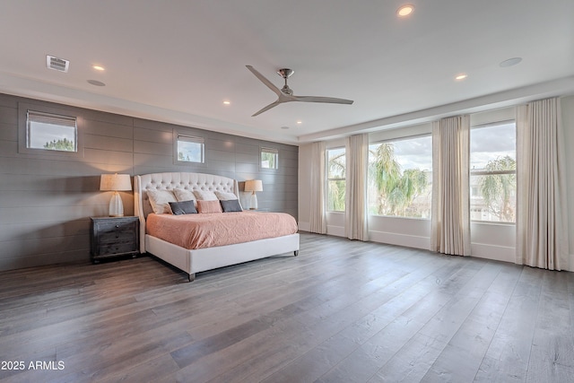 bedroom featuring multiple windows, ceiling fan, and light wood-type flooring