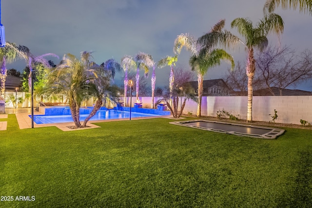 view of yard with a fenced in pool