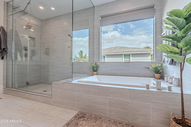 bathroom with separate shower and tub, a wealth of natural light, and tile patterned floors