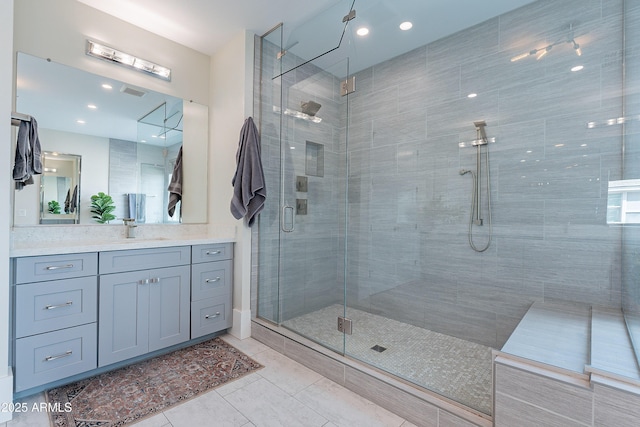 bathroom featuring tile patterned flooring, vanity, and an enclosed shower