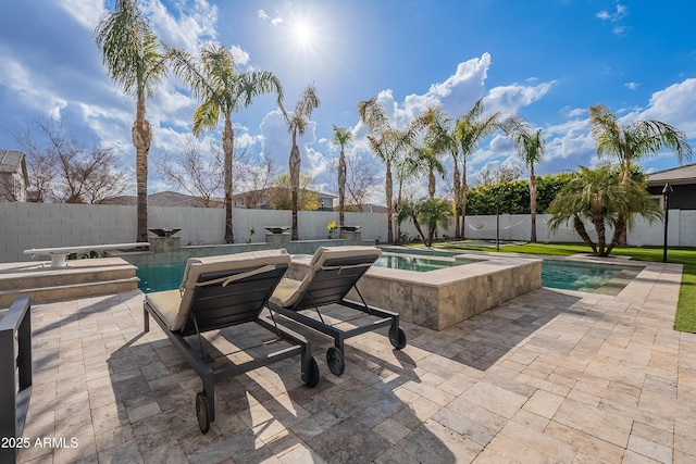 view of patio / terrace featuring a swimming pool with hot tub