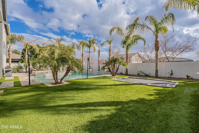 view of yard with a fenced in pool