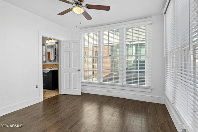 unfurnished bedroom with dark hardwood / wood-style floors, ensuite bath, ceiling fan, and sink