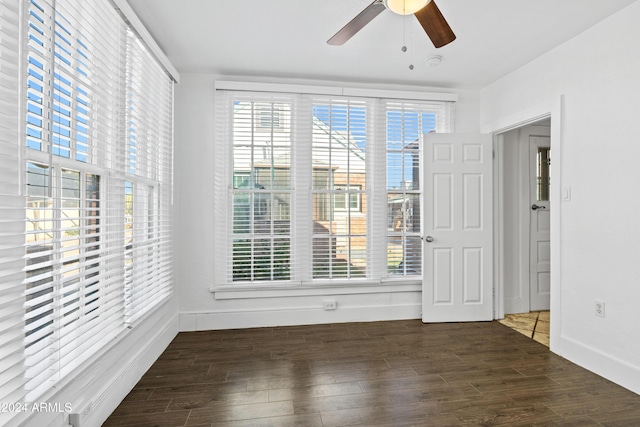 empty room featuring ceiling fan and dark wood-type flooring