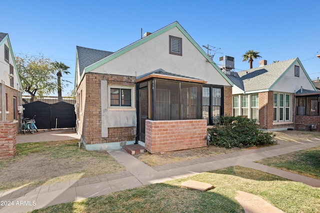 view of front of house with a sunroom