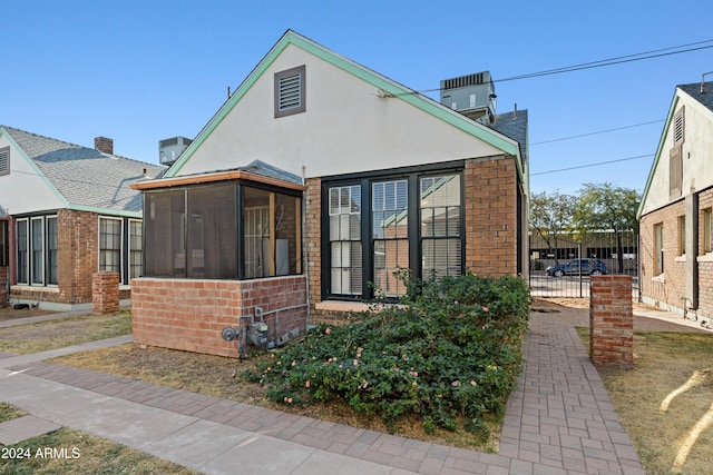 back of house featuring cooling unit and a sunroom