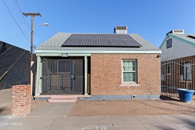 back of house with solar panels