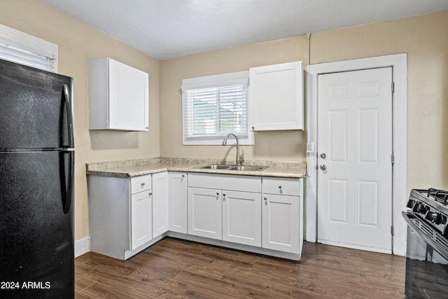 kitchen featuring sink, white cabinetry, dark wood-type flooring, and black appliances