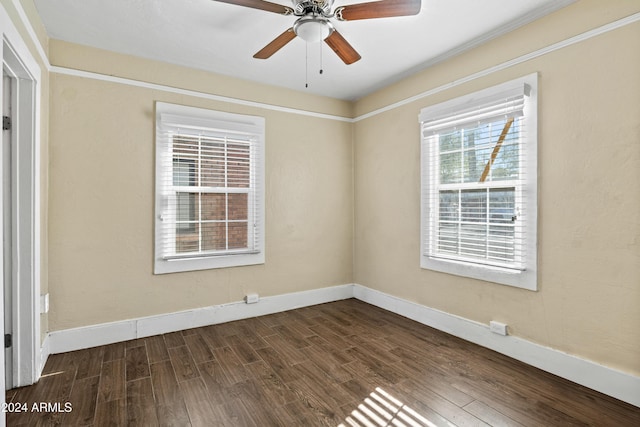 empty room with ceiling fan and dark hardwood / wood-style flooring