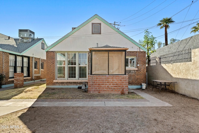 rear view of house featuring central air condition unit