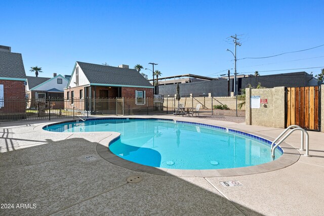 view of swimming pool featuring an outbuilding and a patio area