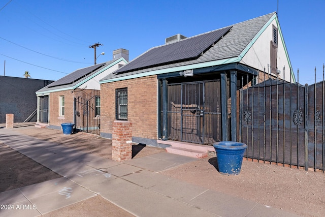 rear view of house with solar panels