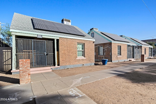 view of front facade featuring solar panels