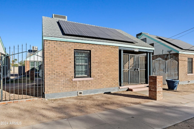 rear view of property with solar panels