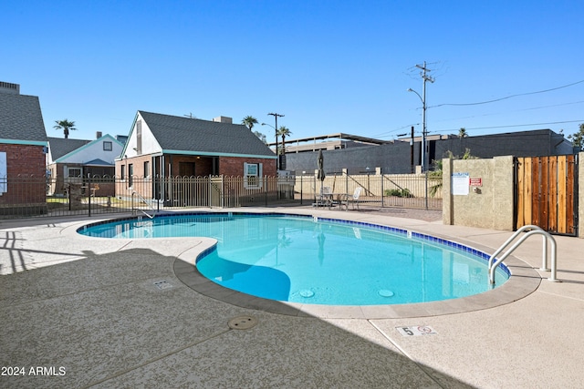 view of pool with a patio area and an outbuilding