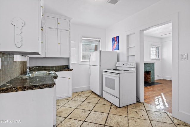 kitchen featuring white cabinetry, sink, ceiling fan, backsplash, and electric stove