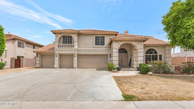 mediterranean / spanish house with a garage