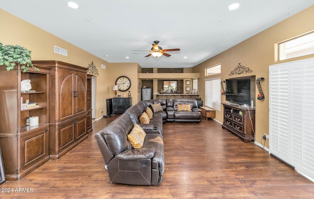 living room with ceiling fan and dark hardwood / wood-style flooring