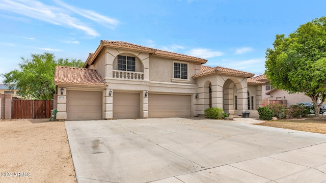 mediterranean / spanish home featuring a garage