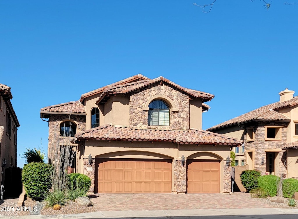 mediterranean / spanish house with a garage