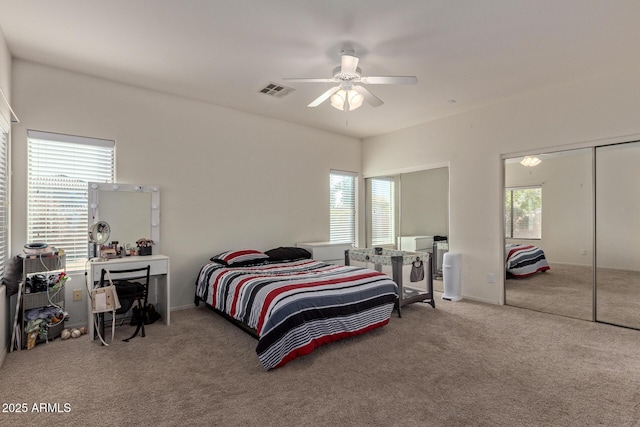 bedroom with a closet, ceiling fan, carpet floors, and multiple windows