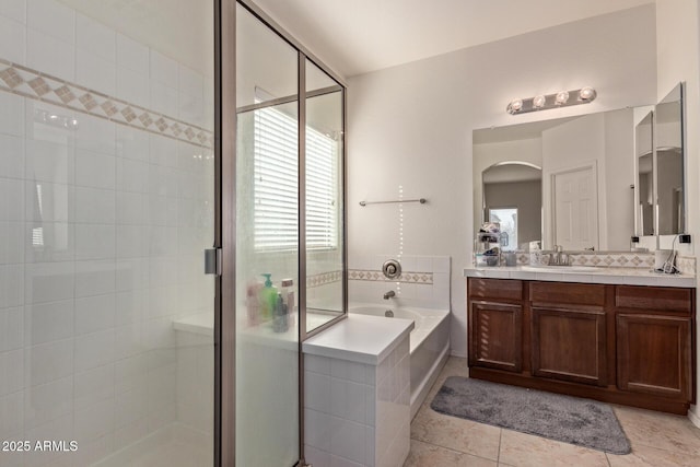 bathroom featuring independent shower and bath, a healthy amount of sunlight, tile patterned floors, and vanity