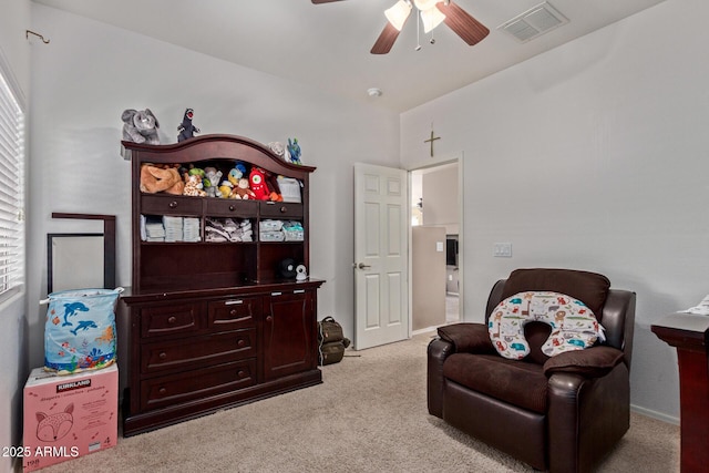 sitting room featuring ceiling fan, plenty of natural light, and light carpet